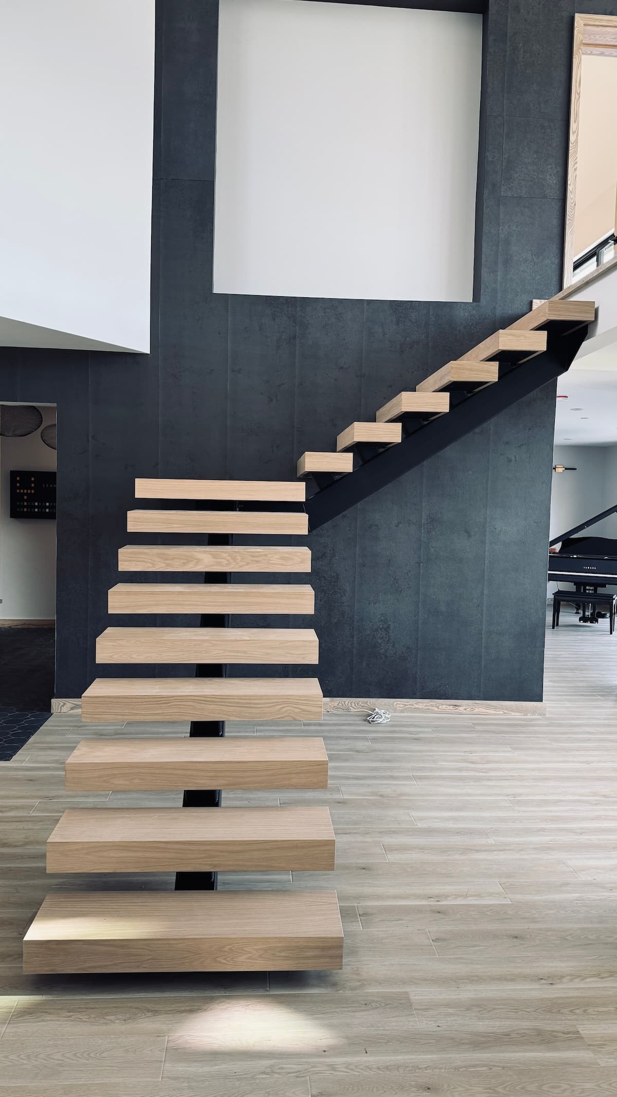 Architectural staircase detail in walnut and brushed steel